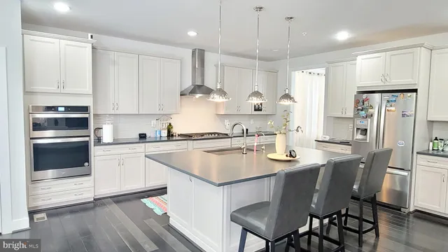 a kitchen with kitchen island a sink stove and cabinets