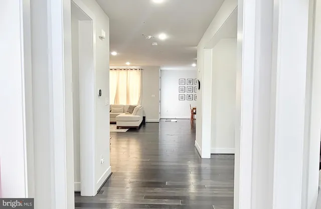 a kitchen with stainless steel appliances kitchen island a table and chairs