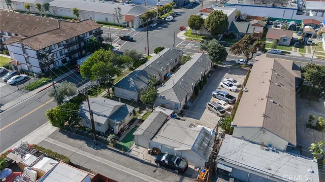 an aerial view of multiple houses with yard