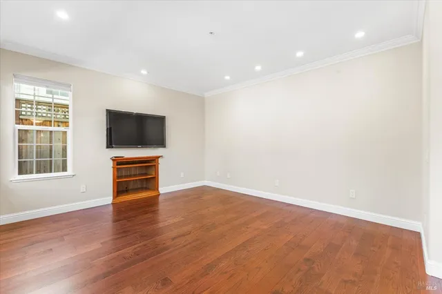a view of room with wooden floor and windows