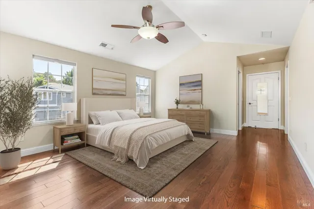 a spacious bedroom with a bed and a chandelier