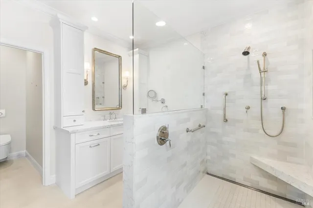a bathroom with a granite countertop sink mirror and a shower