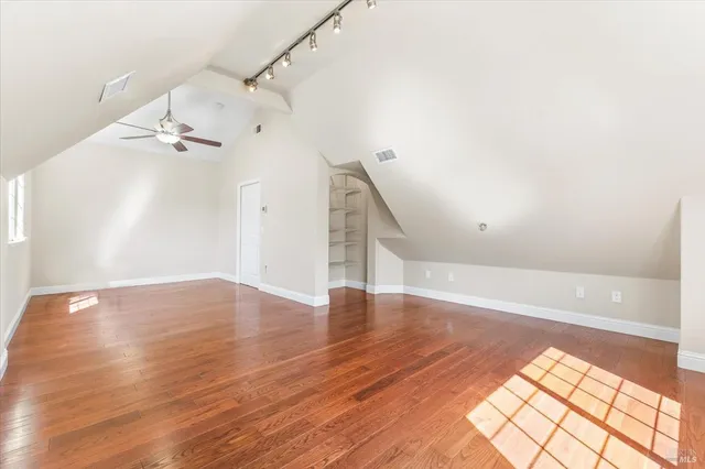 a view of a ceiling fan and wooden floor