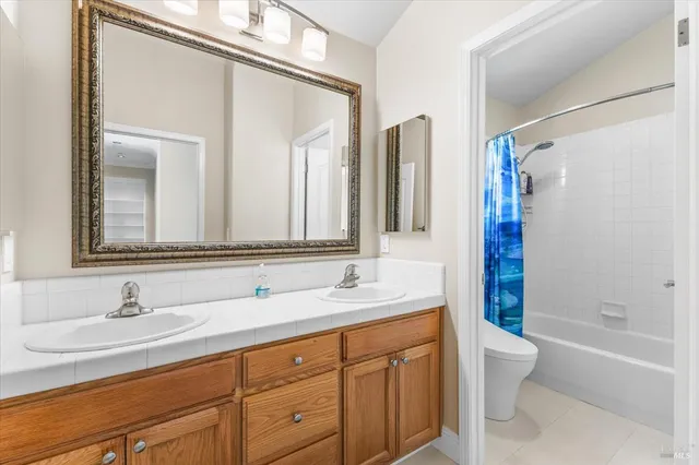 a bathroom with a double vanity sink and a mirror