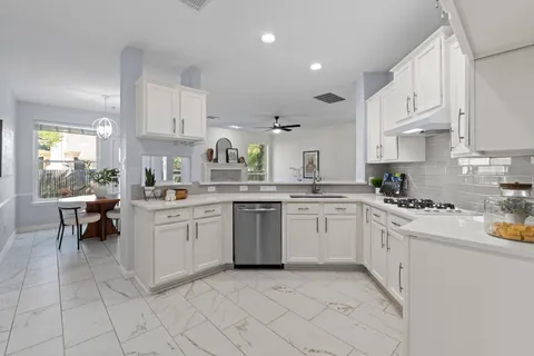 a kitchen with stainless steel appliances a refrigerator sink and cabinets
