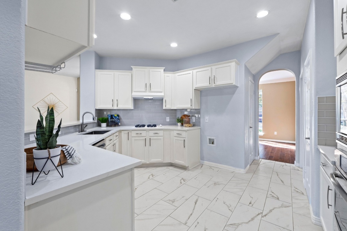 1601 Michael Robert Way Cedar Park, TX 78613 - Photo 12 of 35 a kitchen with a refrigerator and white cabinets