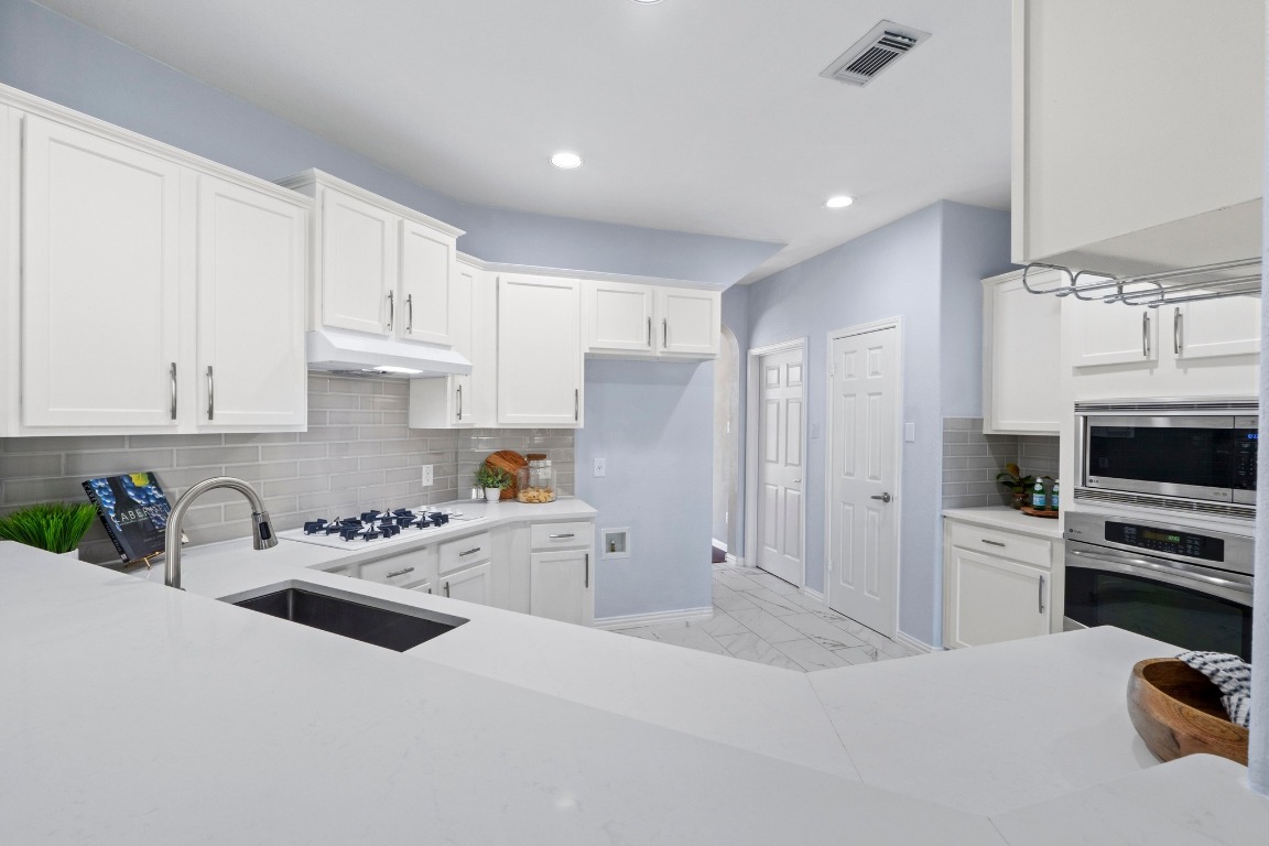 1601 Michael Robert Way Cedar Park, TX 78613 - Photo 13 of 35 a kitchen with stainless steel appliances a refrigerator sink and cabinets