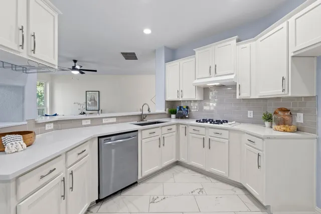 a dining room with furniture a chandelier and wooden floor