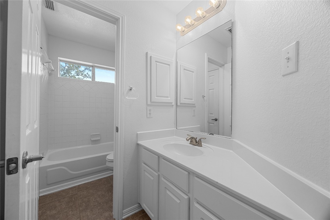 1601 Michael Robert Way Cedar Park, TX 78613 - Photo 28 of 35 a bathroom with a sink a shower and a mirror