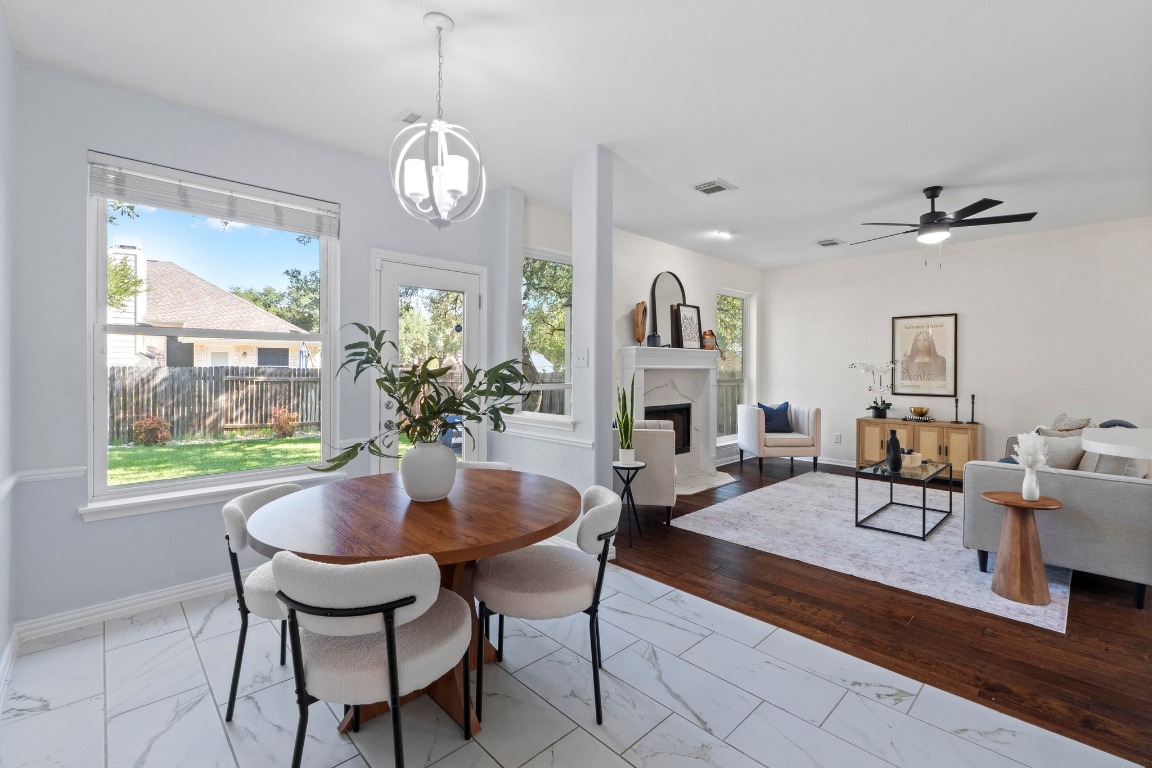 1601 Michael Robert Way Cedar Park, TX 78613 - Photo 3 of 35 a dining room with furniture a chandelier and wooden floor