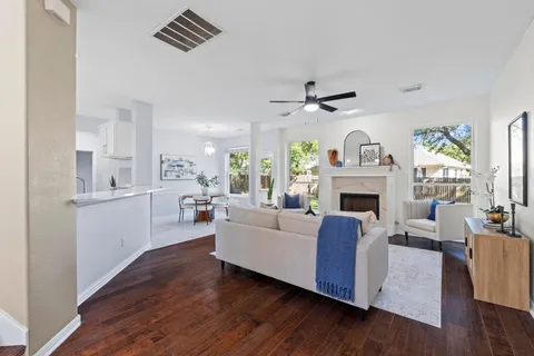 a living room with furniture and a wooden floor