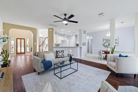 a kitchen with a refrigerator and white cabinets