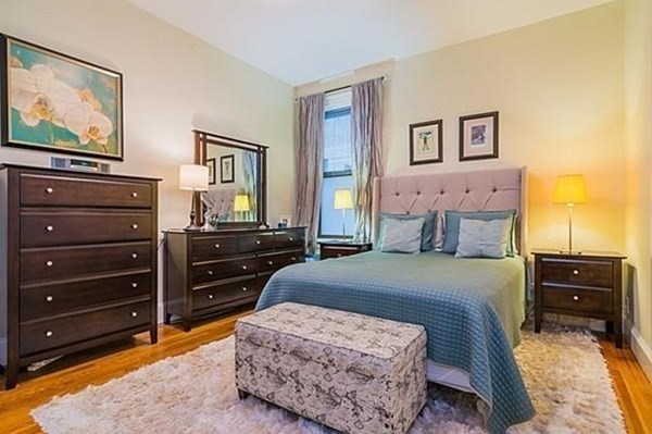 1060 Beacon Street, Unit 5 Brookline, MA 02446 - Photo 3 of 6 a bedroom with a bed and a mirror