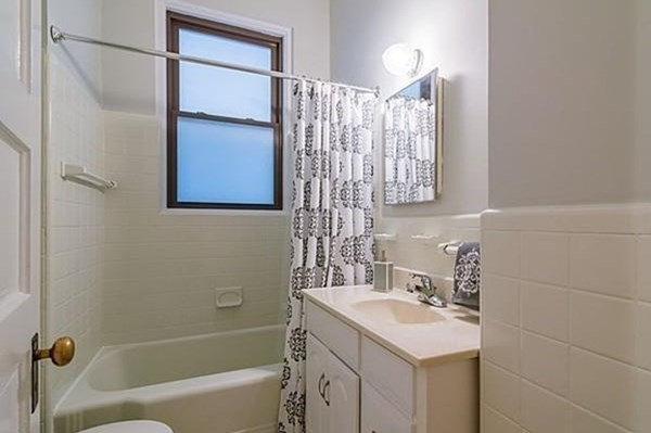 1060 Beacon Street, Unit 5 Brookline, MA 02446 - Photo 5 of 6 a bathroom with a sink toilet tub and shower