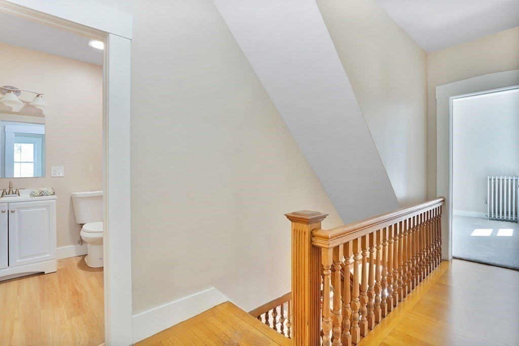 123 Springfield Street Chicopee, MA 01013 - Photo 18 of 42 a view of a hallway with bathroom and wooden floor