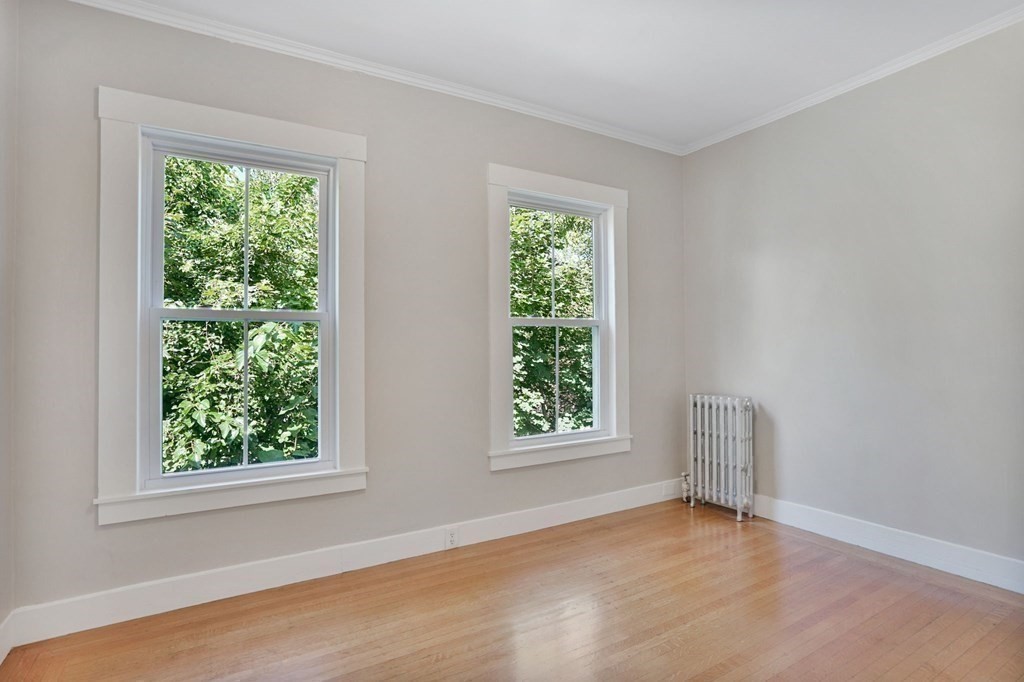 123 Springfield Street Chicopee, MA 01013 - Photo 21 of 42 an empty room with wooden floor and windows