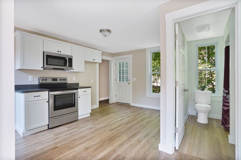 123 Springfield Street Chicopee, MA 01013 - Photo 34 of 42 a kitchen with a refrigerator and a stove top oven