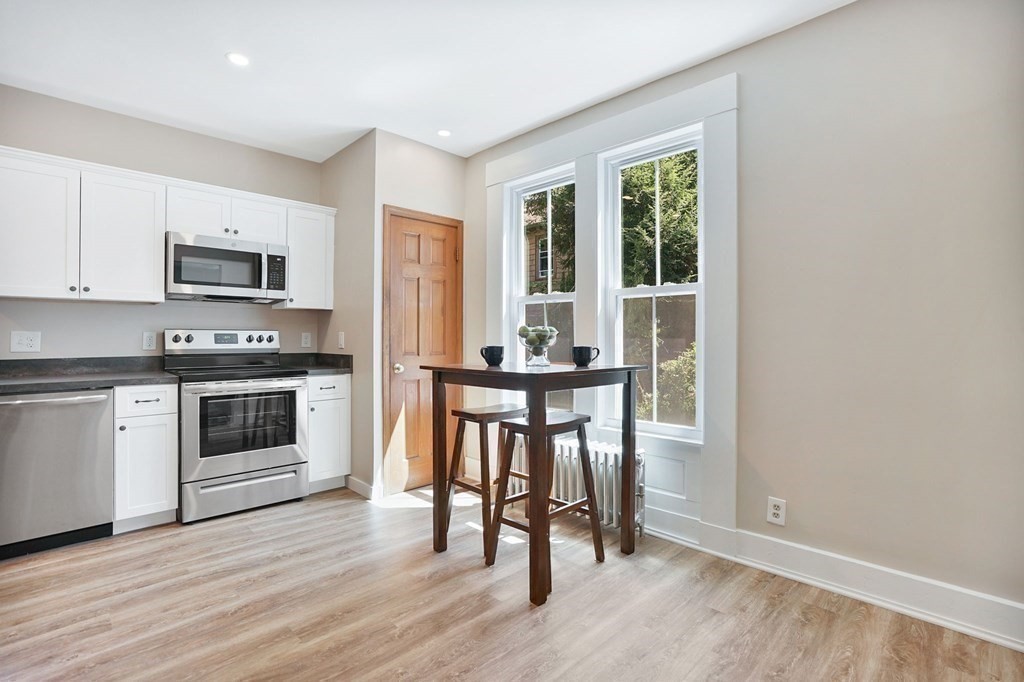 123 Springfield Street Chicopee, MA 01013 - Photo 4 of 42 a kitchen with granite countertop a stove a sink and a refrigerator