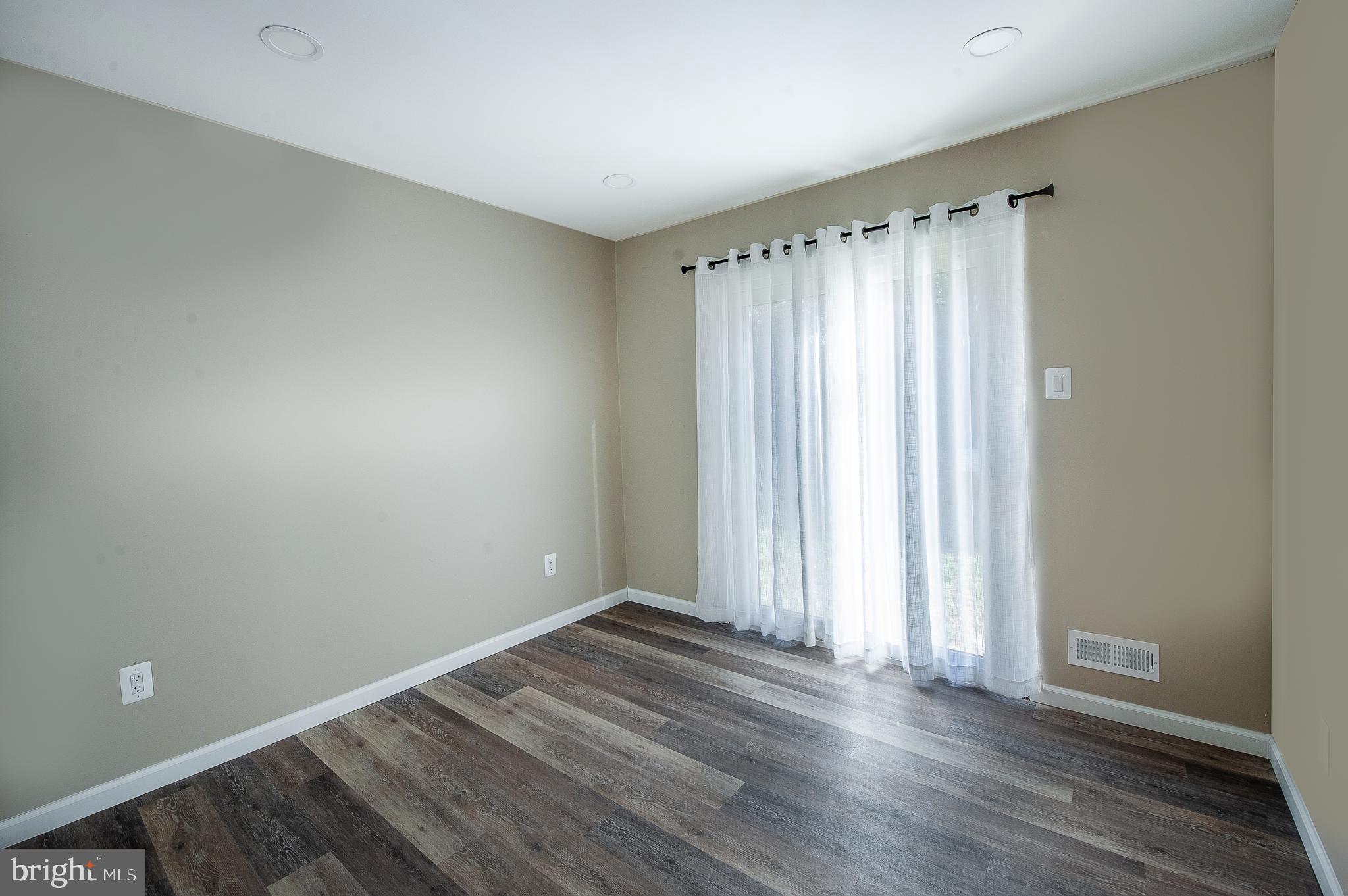 1010 Huntingdon Mews Clementon, NJ 08021 - Photo 12 of 19 an empty room with wooden floor and a window