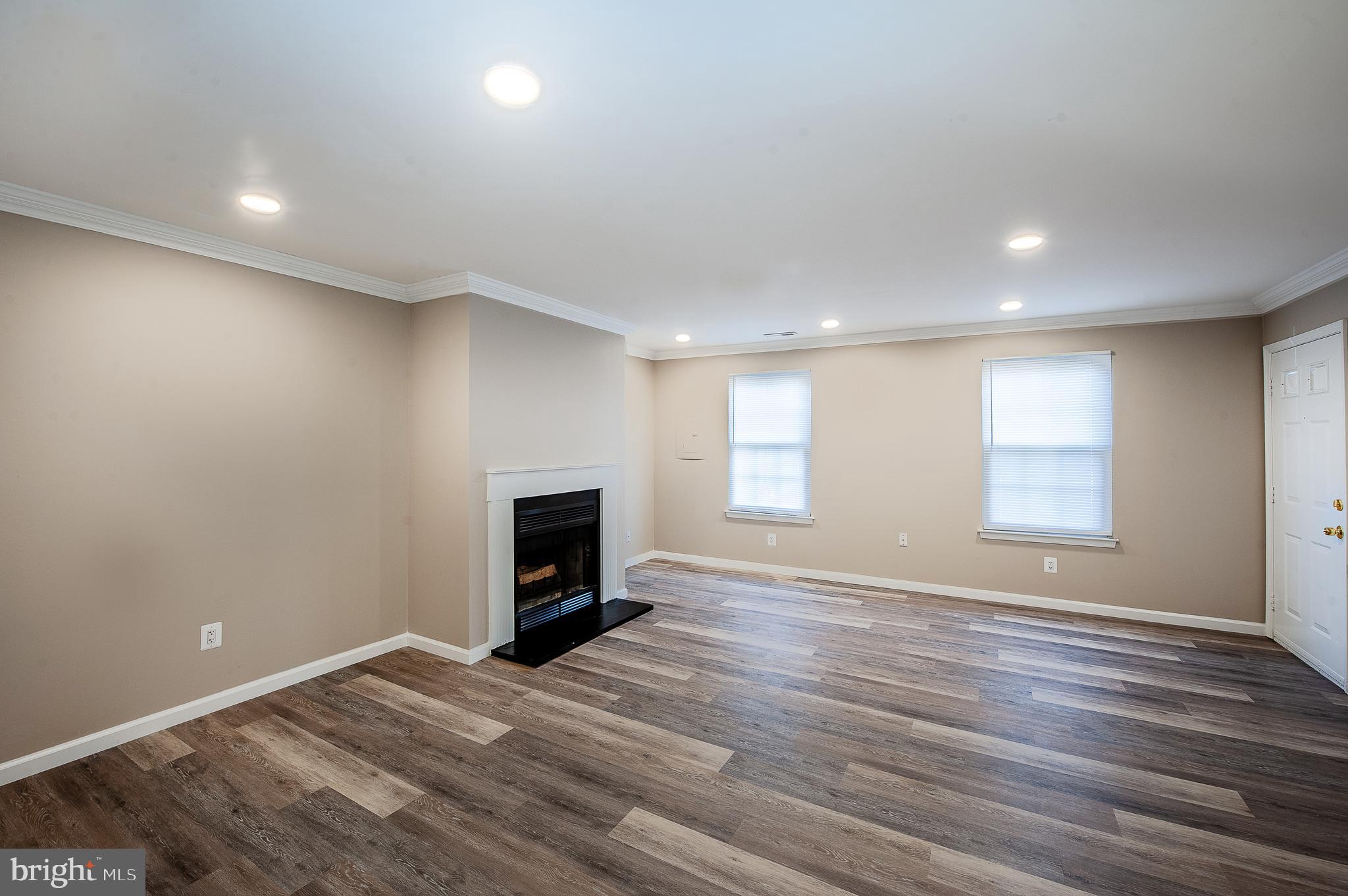 1010 Huntingdon Mews Clementon, NJ 08021 - Photo 4 of 19 an empty room with wooden floor and a window