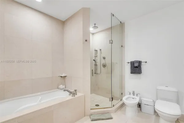 a bathroom with a toilet a sink and shower