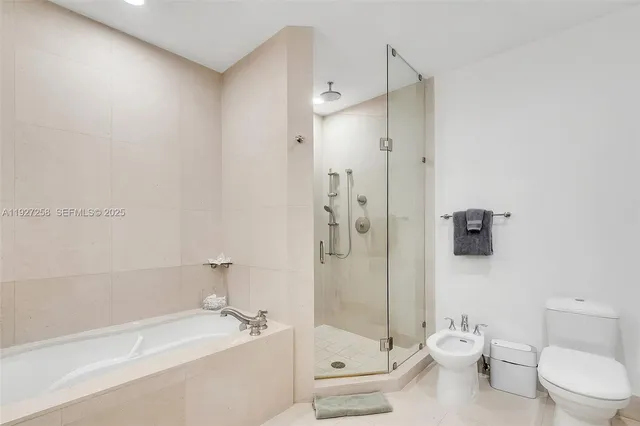 a bathroom with a toilet a sink and shower