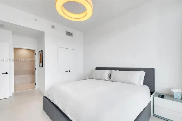 a bedroom with a bed and a lamp