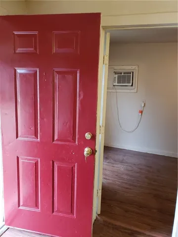 a view of a livingroom with wooden floor and cabinet