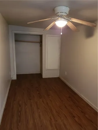a view of a small space with wooden floor and staircase