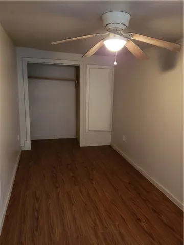 a view of a small space with wooden floor and staircase