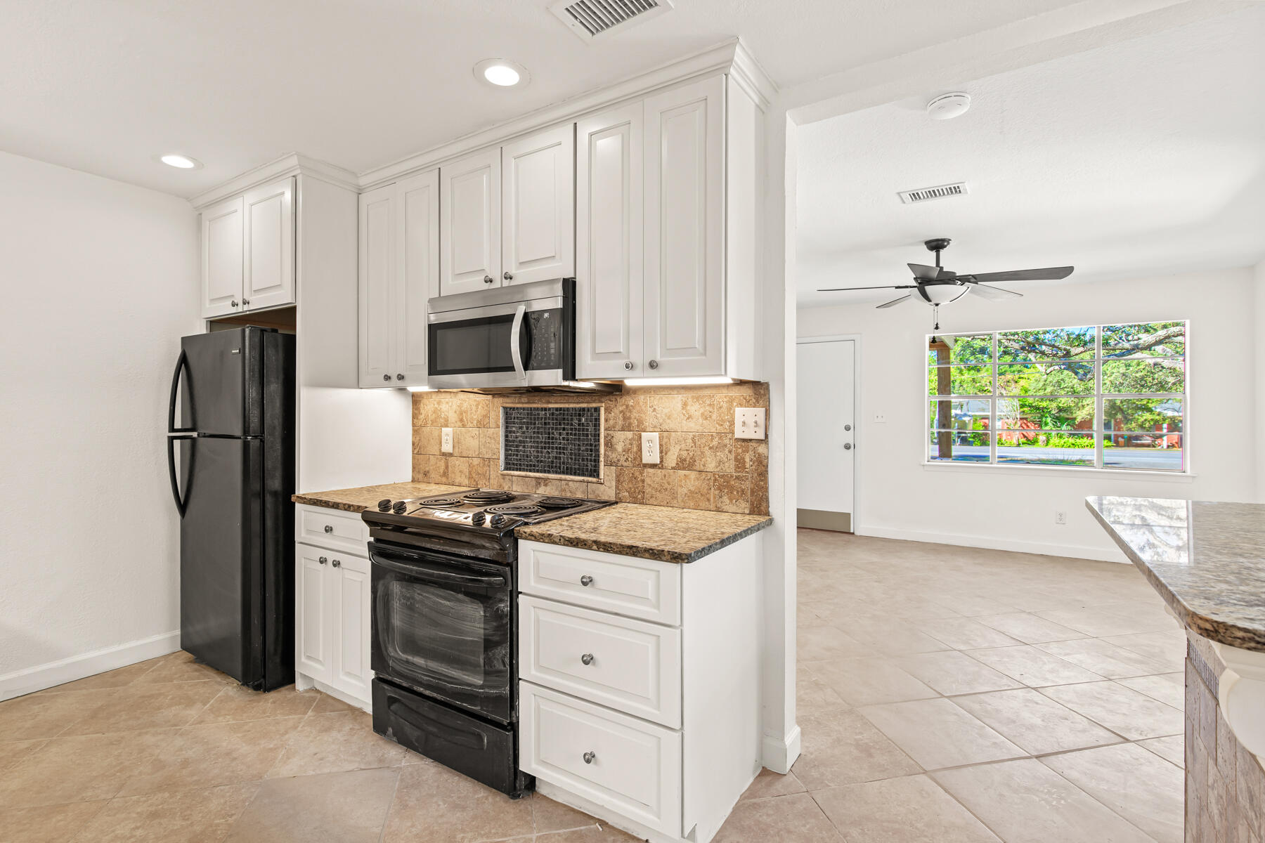 612 Beach Drive Destin, FL 32541 - Photo 15 of 34 a kitchen with stainless steel appliances a stove refrigerator and microwave