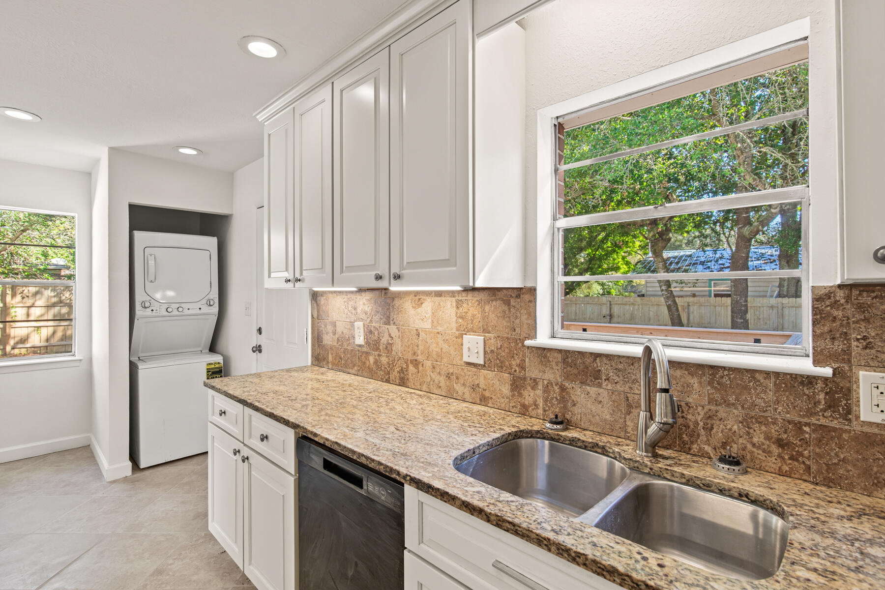 612 Beach Drive Destin, FL 32541 - Photo 16 of 34 a kitchen with granite countertop a sink and a window