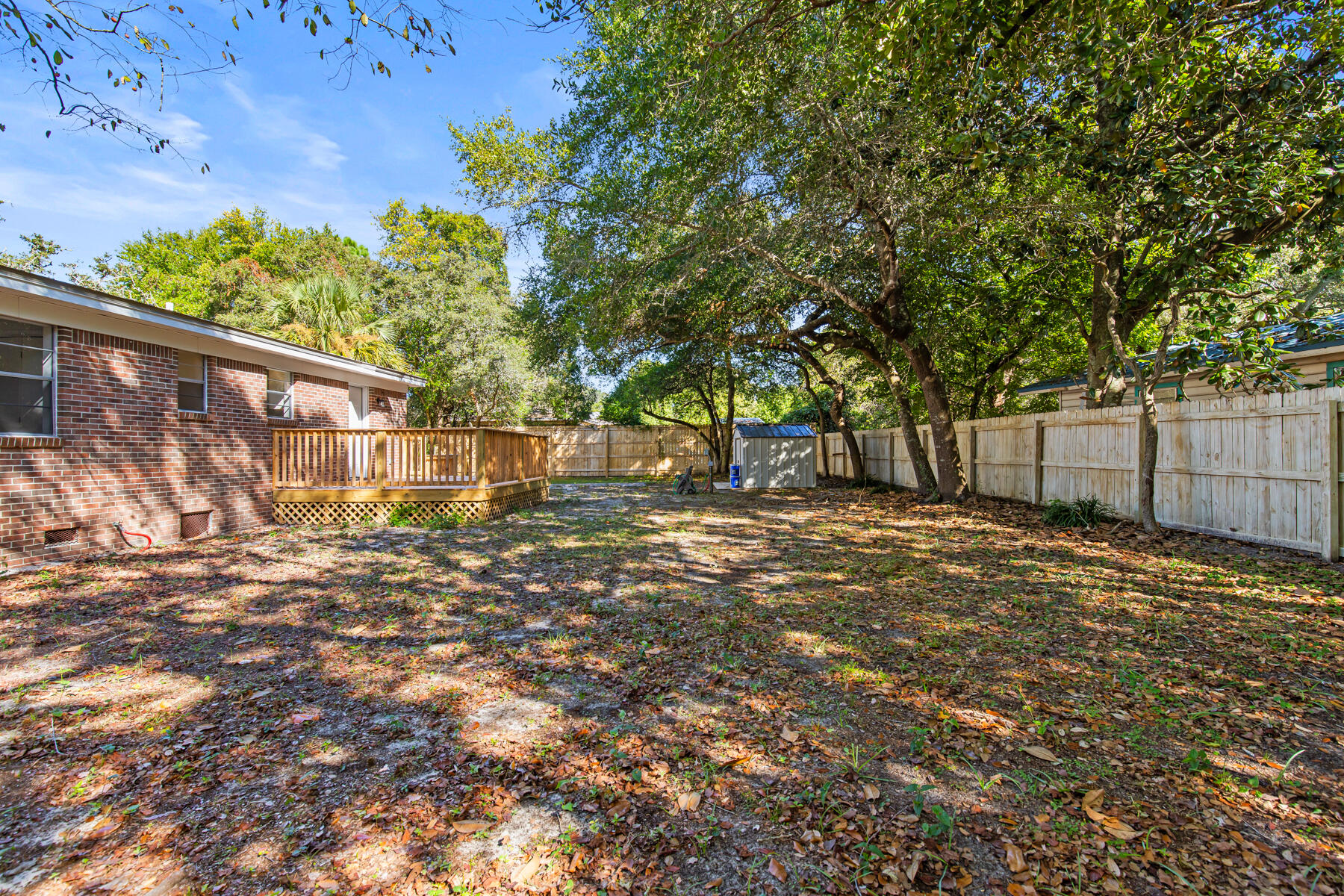 612 Beach Drive Destin, FL 32541 - Photo 24 of 34 a view of a yard with wooden fence
