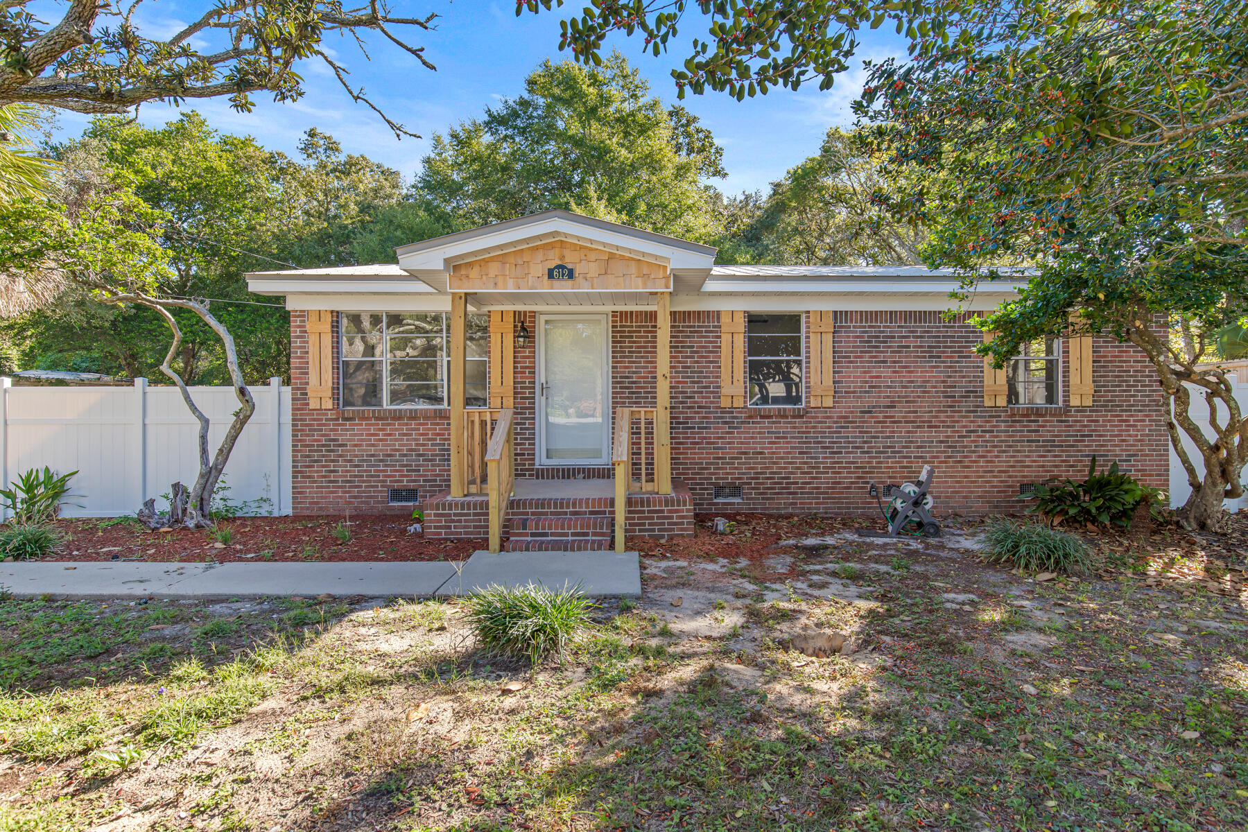 612 Beach Drive Destin, FL 32541 - Photo 3 of 34 a view of a house with a yard