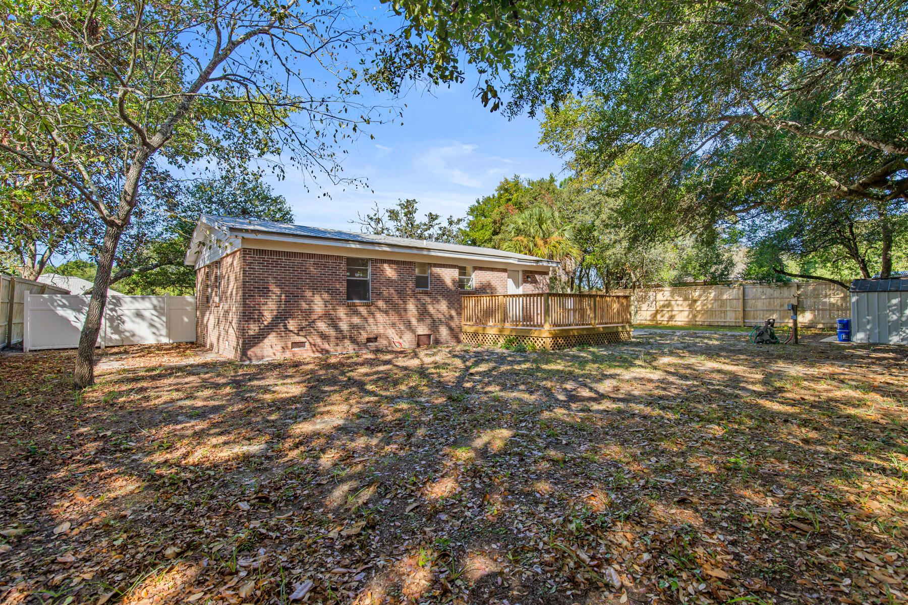 612 Beach Drive Destin, FL 32541 - Photo 7 of 34 a view of a yard with a tree