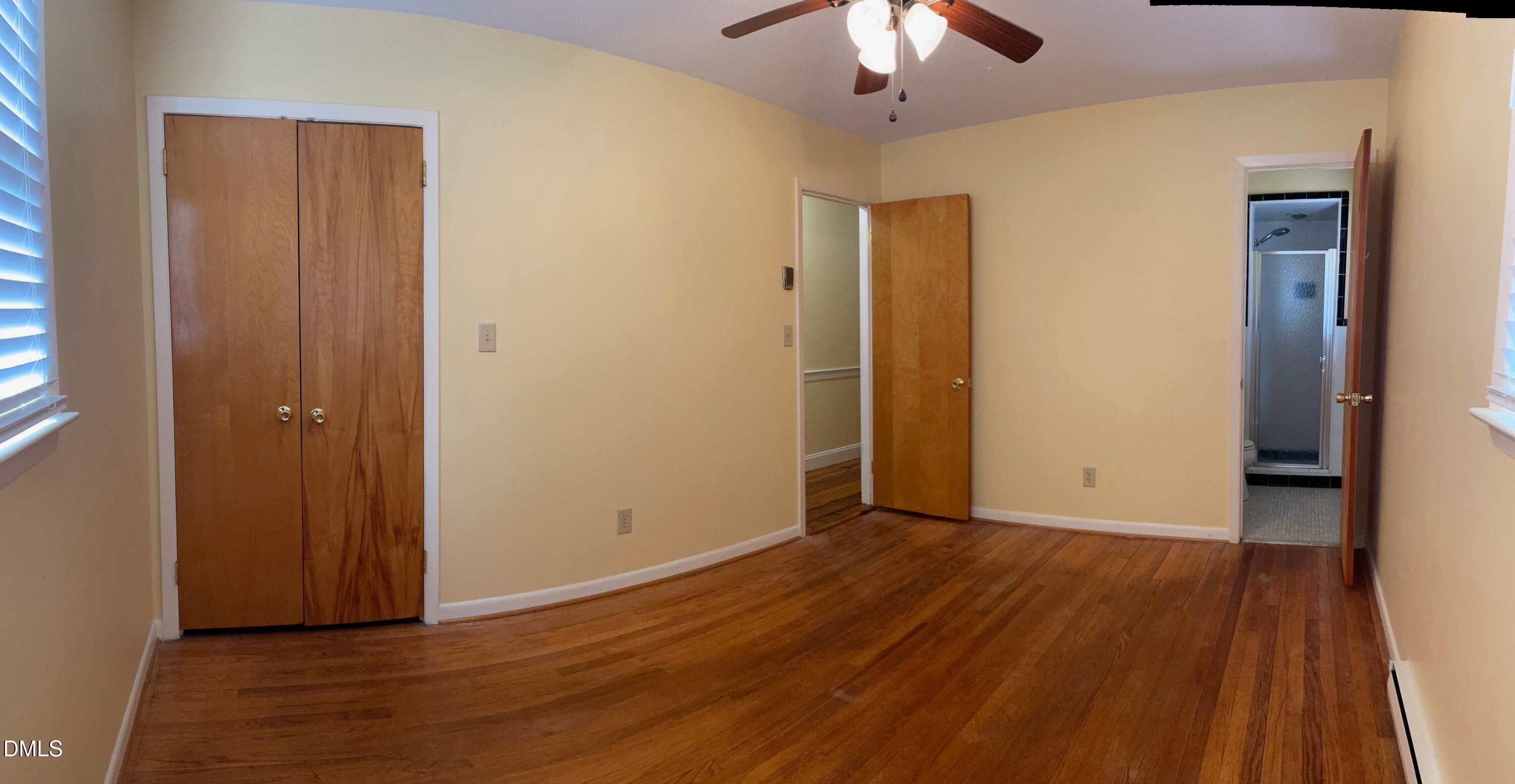 280 Montague Road Angier, NC 27501 - Photo 18 of 28 an empty room with wooden floor and a ceiling fan