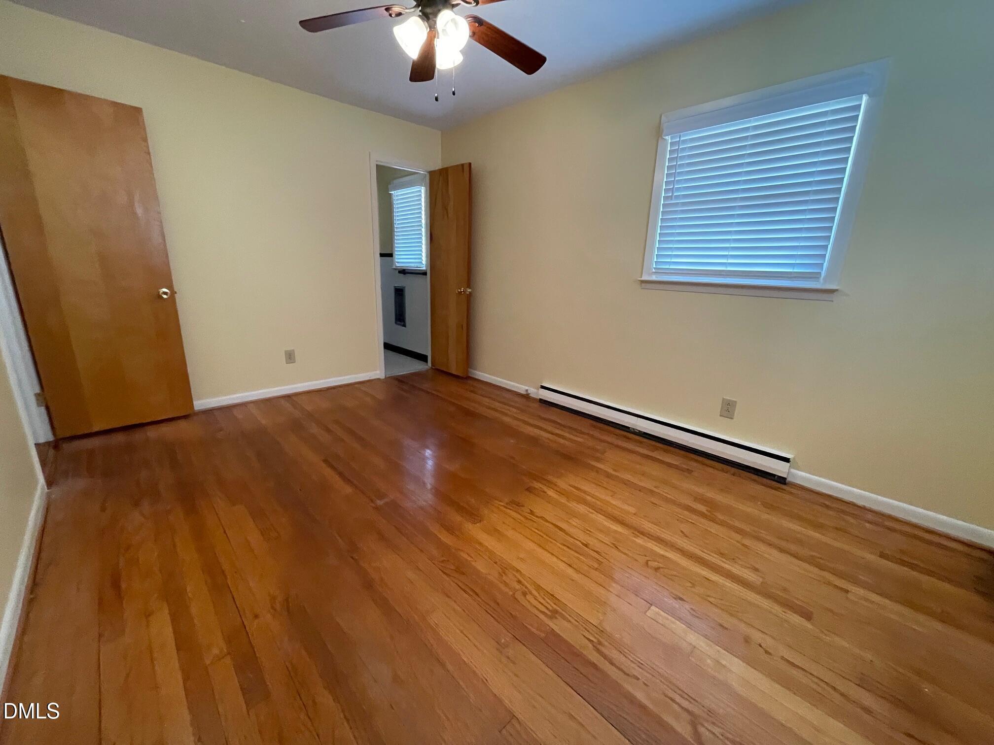 280 Montague Road Angier, NC 27501 - Photo 19 of 28 a view of an empty room with a window and wooden floor