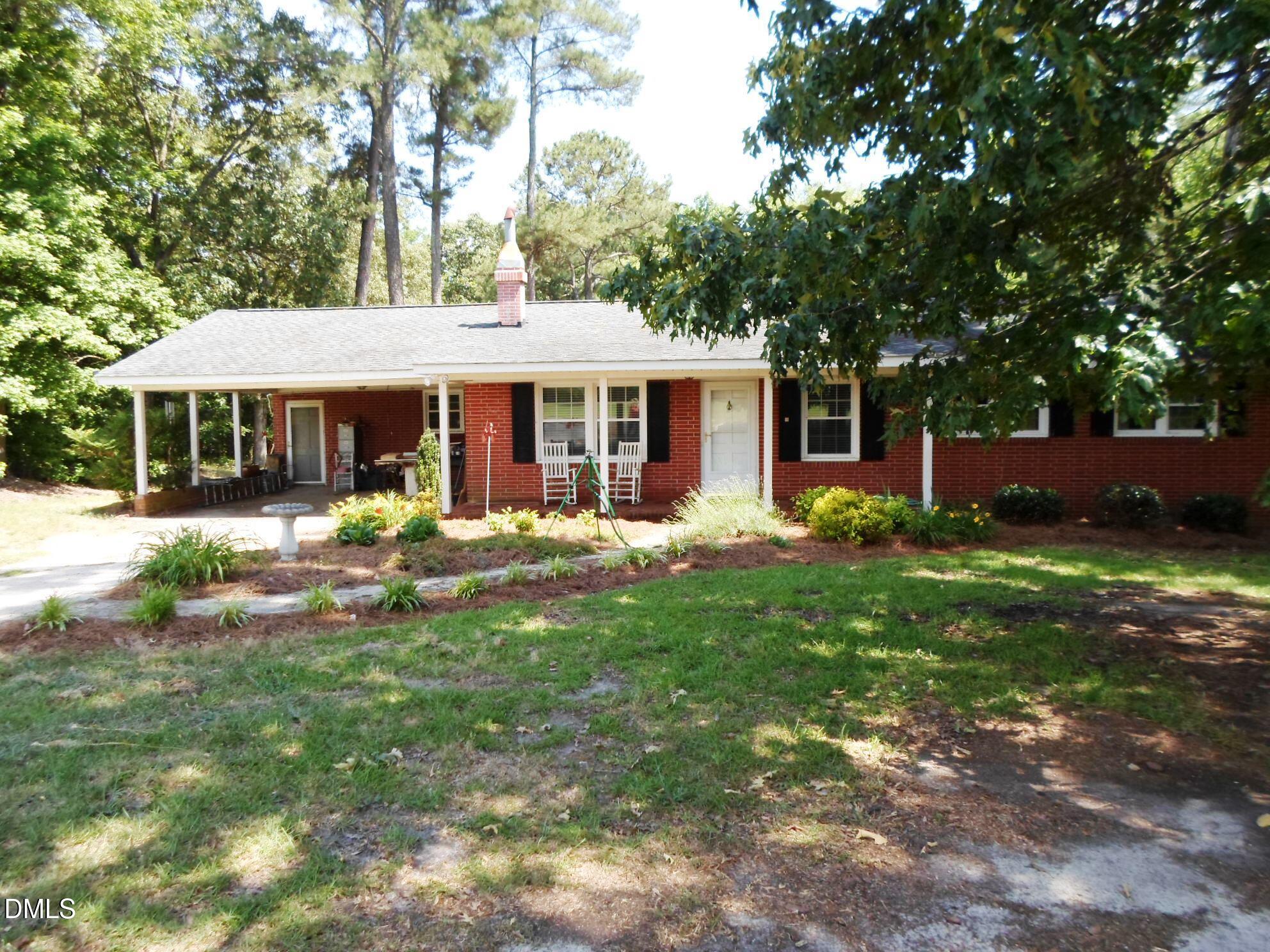 280 Montague Road Angier, NC 27501 - Photo 2 of 28 a front view of a house with garden and trees