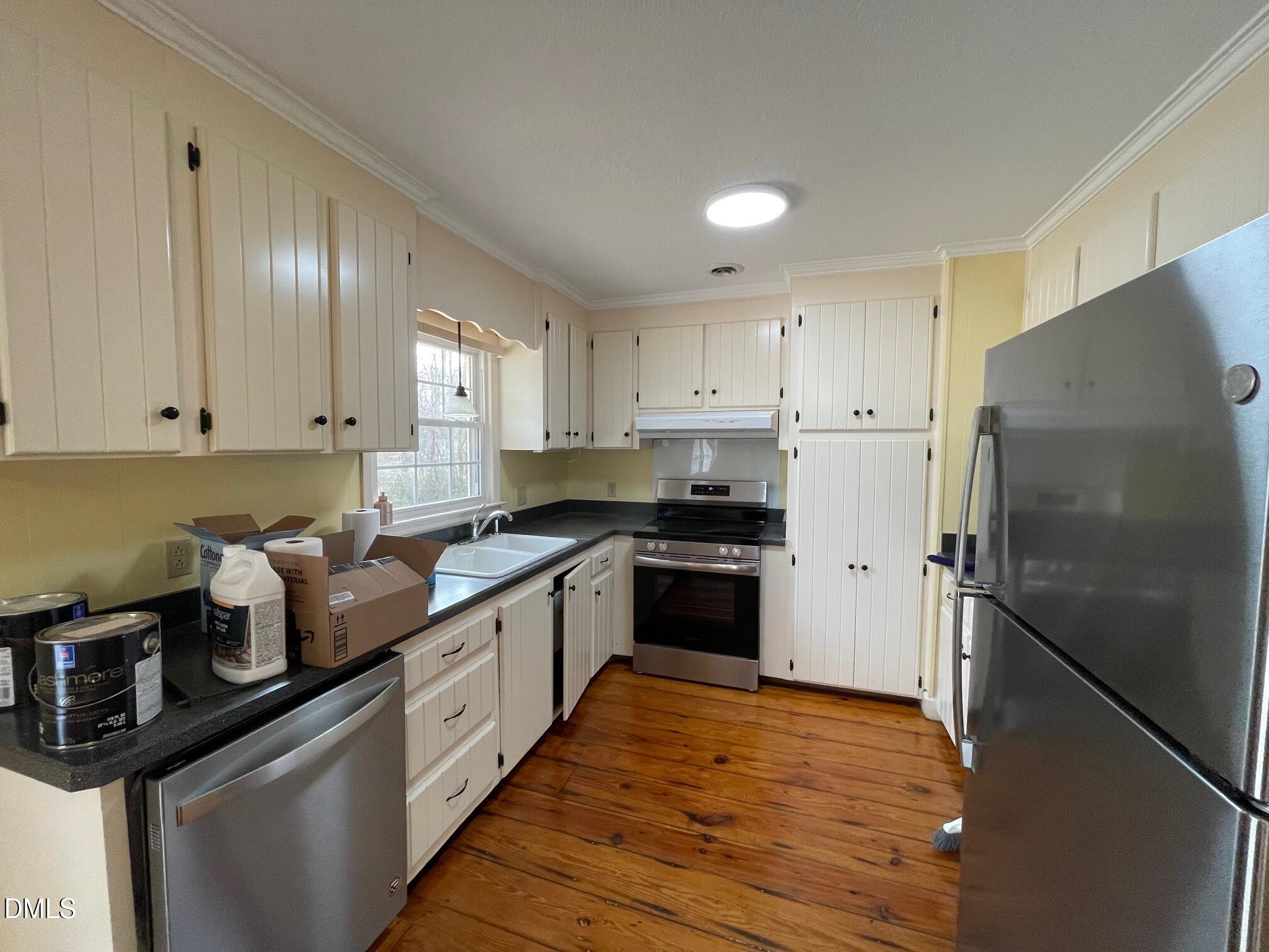 280 Montague Road Angier, NC 27501 - Photo 23 of 28 a kitchen with granite countertop stainless steel appliances and wooden cabinets