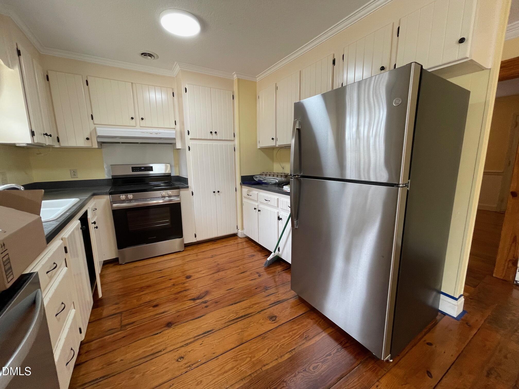 280 Montague Road Angier, NC 27501 - Photo 24 of 28 a kitchen with a refrigerator sink and wooden floor