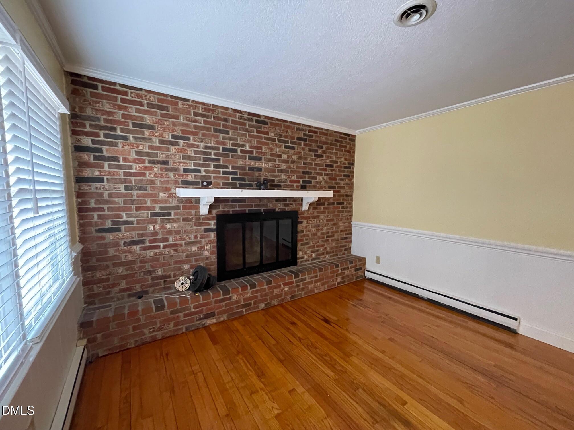 280 Montague Road Angier, NC 27501 - Photo 4 of 28 a room with fireplace and wooden floor