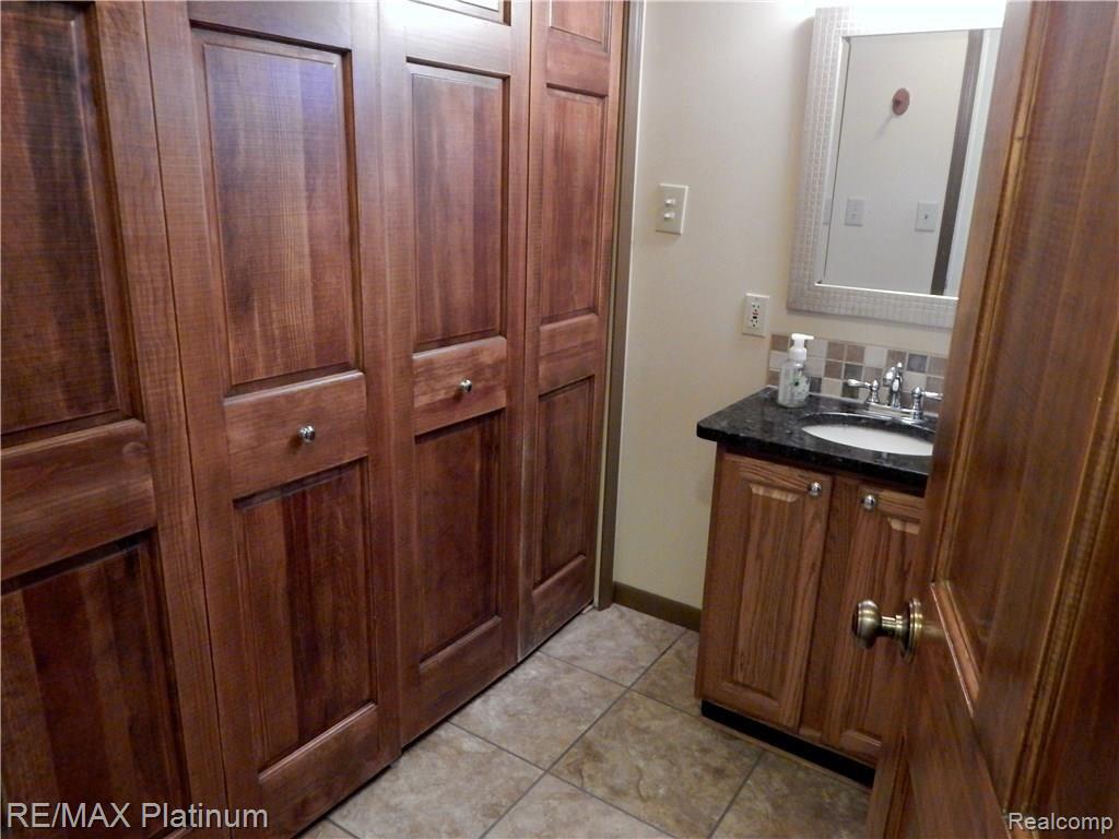 86 South Burkhart Road Howell, MI 48843 - Photo 24 of 52 Main Floor Full Bath is updated and has full Laundry Facilities behind these solid wood doors!
