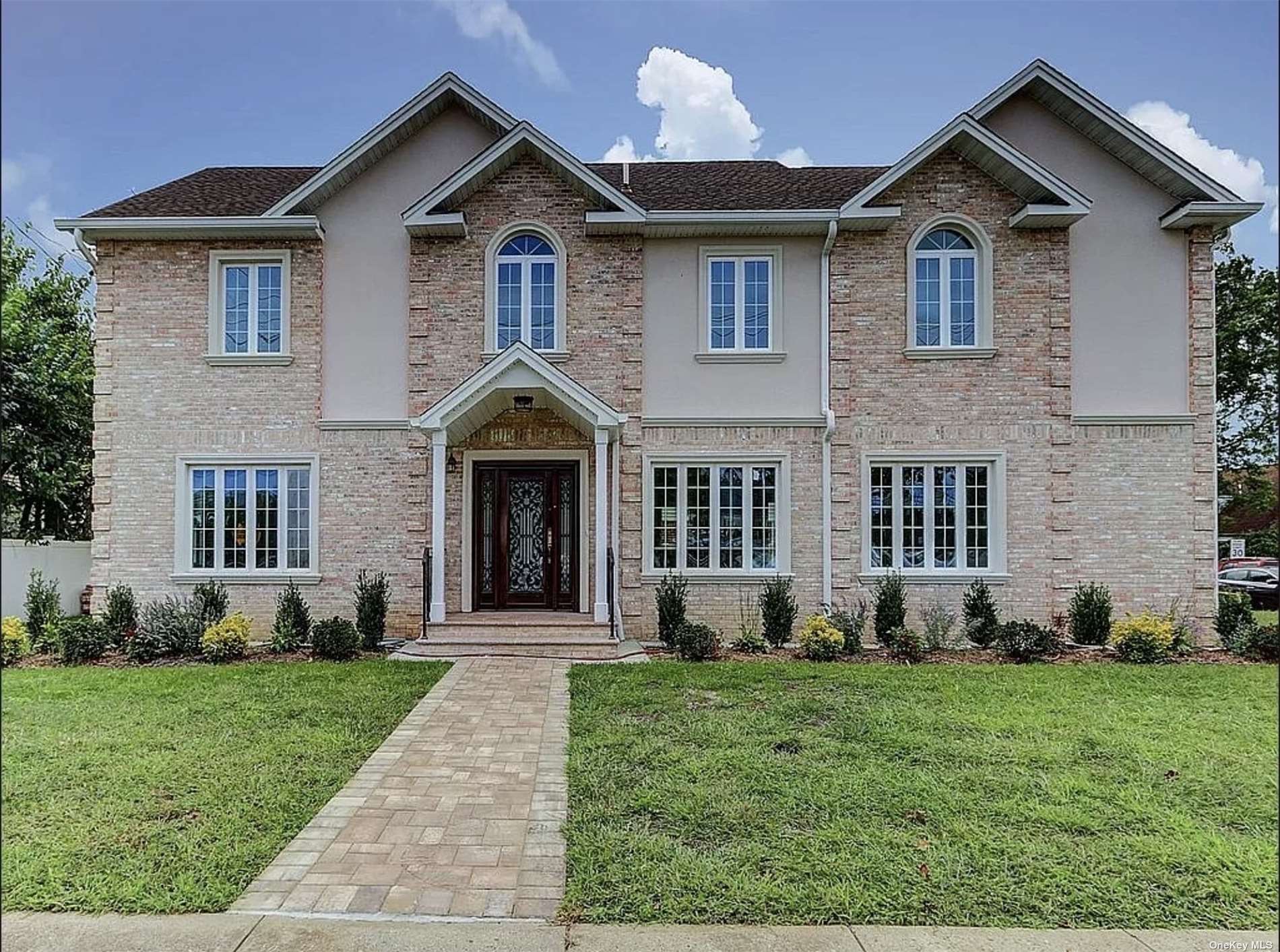 a front view of a house with garden