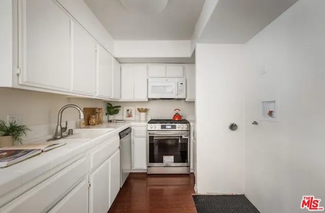 a kitchen with stainless steel appliances granite countertop a sink and cabinets