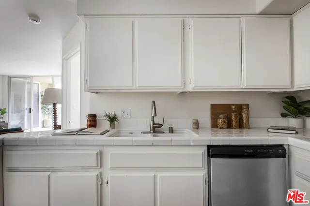 a kitchen with stainless steel appliances granite countertop a sink and cabinets