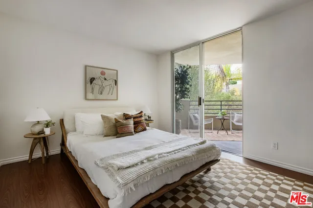 a bedroom with a bed and a lamp next to a window