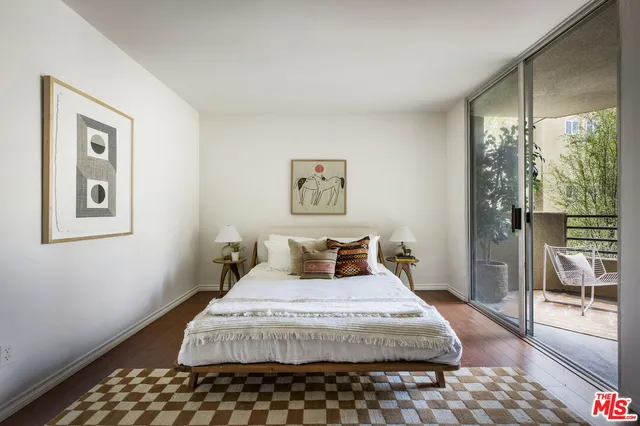 a bedroom with a large bed and a large window