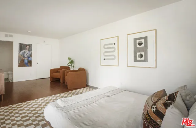 a bedroom with a bed and a couch