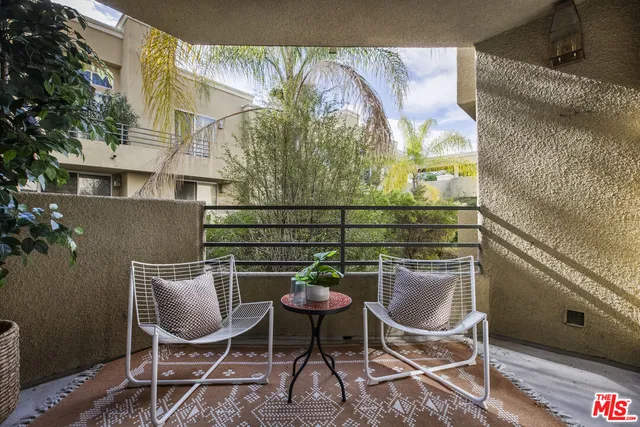 a balcony with table and chairs