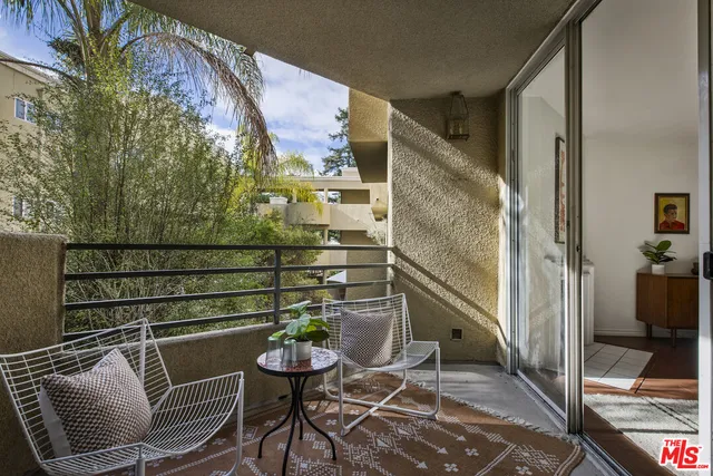 a balcony with table and chairs
